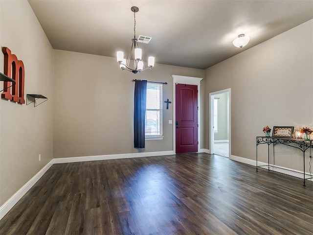 interior space featuring dark hardwood / wood-style flooring and a chandelier