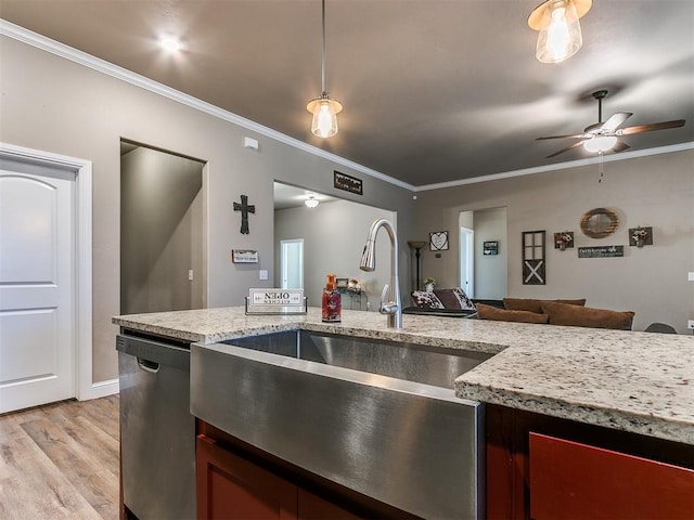 kitchen featuring crown molding, stainless steel dishwasher, light hardwood / wood-style floors, and sink