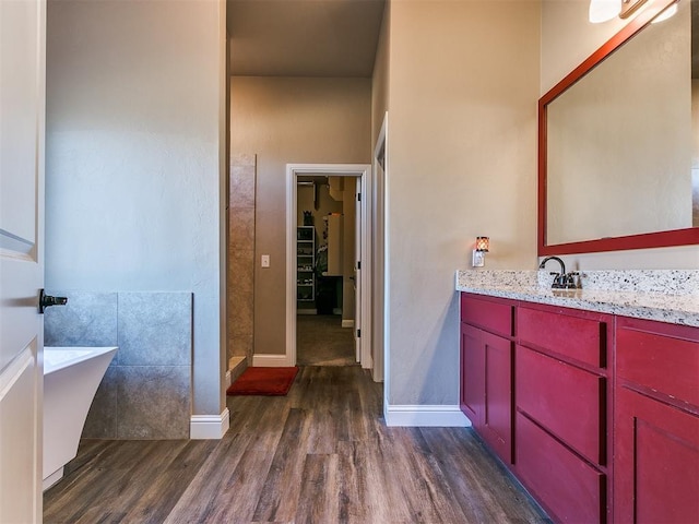 bathroom featuring hardwood / wood-style flooring, vanity, and shower with separate bathtub