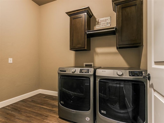 washroom featuring dark hardwood / wood-style flooring, cabinets, and washer and dryer