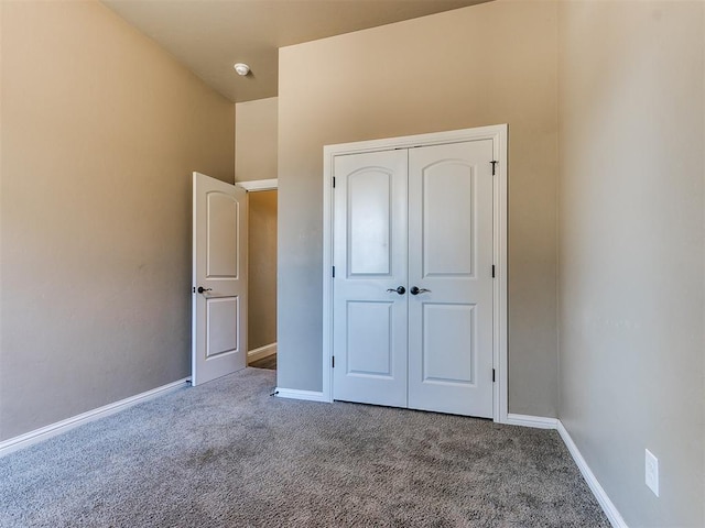 unfurnished bedroom featuring carpet floors and a closet