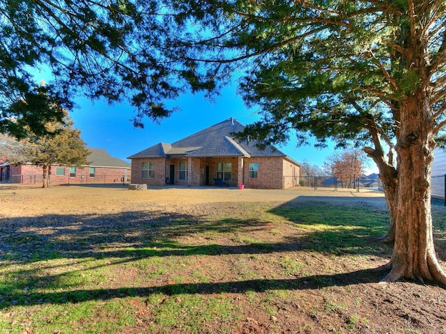 ranch-style home featuring a front yard