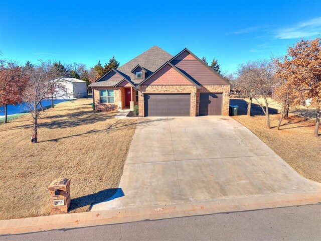 view of front facade featuring an attached garage, stone siding, a front yard, and concrete driveway