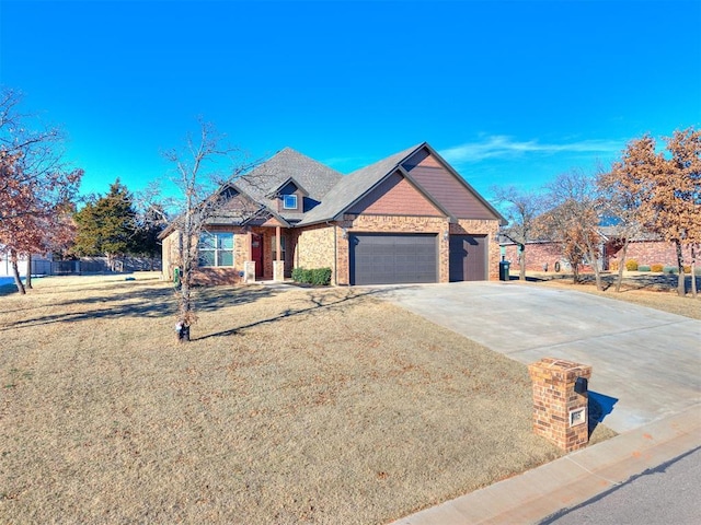 view of front of house with a garage, brick siding, a front yard, and concrete driveway