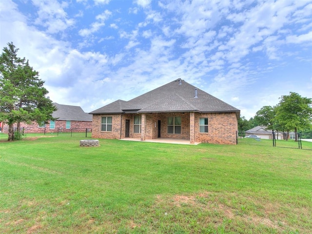 9015 Tall Oaks Dr, Guthrie, OK 73044 - rear view of property with a patio, a fire pit, brick siding, and roof with shingles