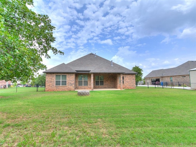 9015 Tall Oaks Dr, Guthrie, OK 73044 - back of house featuring a fire pit, brick siding, a shingled roof, and a patio