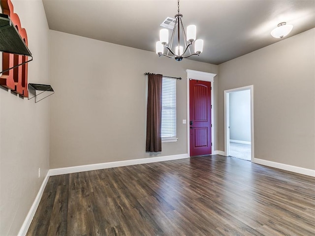 9015 Tall Oaks Dr, Guthrie, OK 73044 - spare room with a chandelier, wood finished floors, and baseboards