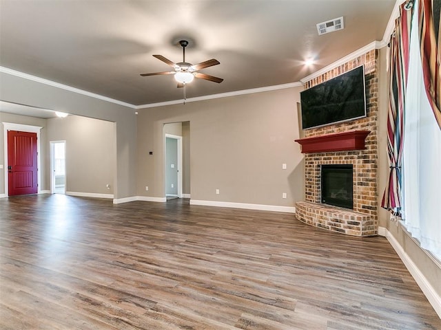 9015 Tall Oaks Dr, Guthrie, OK 73044 - unfurnished living room with ceiling fan, a brick fireplace, wood finished floors, crown molding, and baseboards