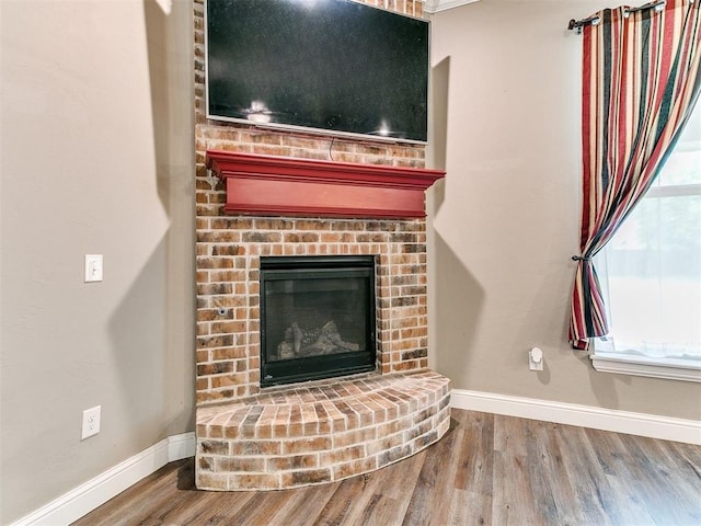9015 Tall Oaks Dr, Guthrie, OK 73044 - detailed view of baseboards, wood finished floors, and a fireplace