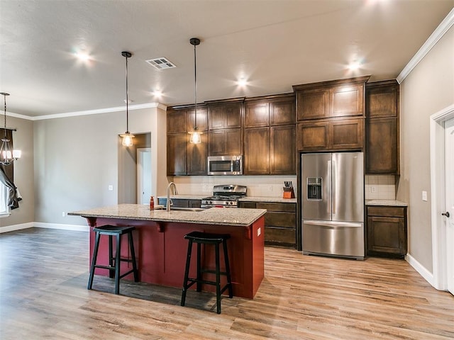 9015 Tall Oaks Dr, Guthrie, OK 73044 - kitchen with stainless steel appliances, ornamental molding, light wood finished floors, backsplash, and baseboards