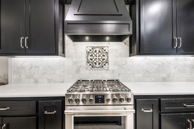 kitchen featuring custom exhaust hood, stainless steel range with gas stovetop, and decorative backsplash