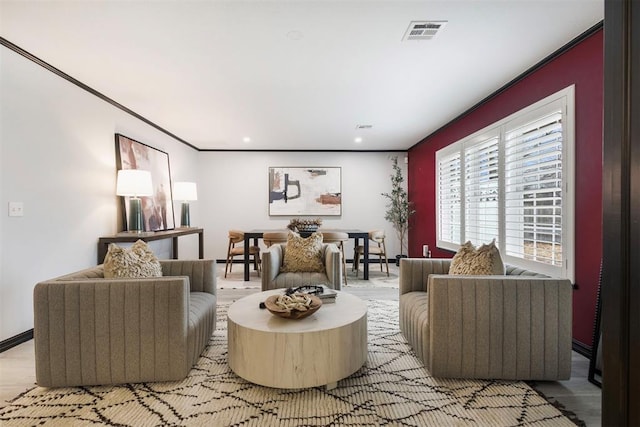 living room featuring ornamental molding and light hardwood / wood-style floors