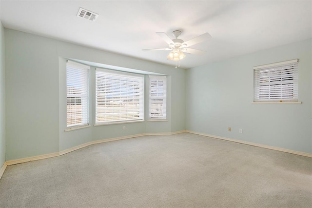 empty room featuring light carpet and ceiling fan