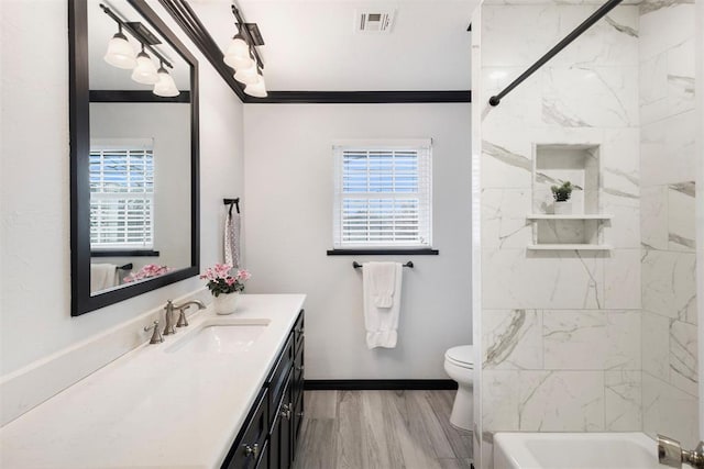 full bathroom featuring crown molding, plenty of natural light, vanity, and hardwood / wood-style flooring