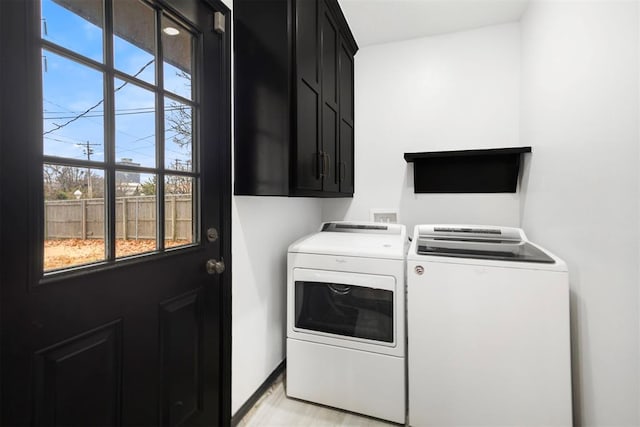 washroom with cabinets and independent washer and dryer