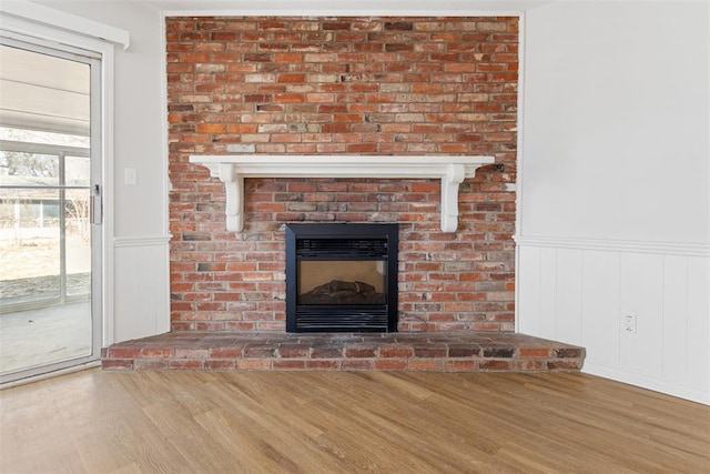 room details featuring wood-type flooring and a brick fireplace