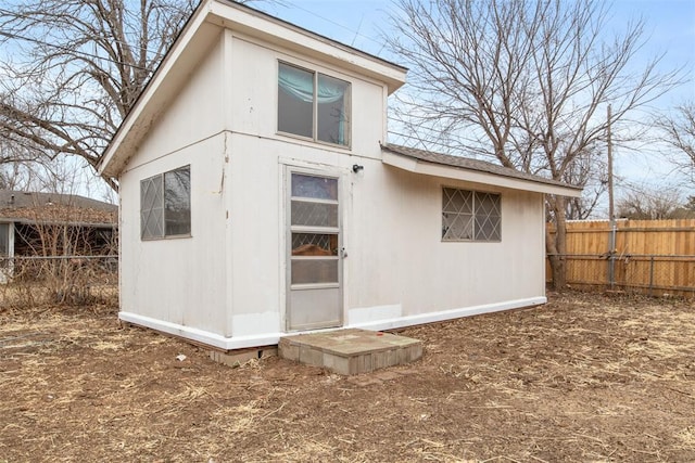 rear view of property with an outdoor structure