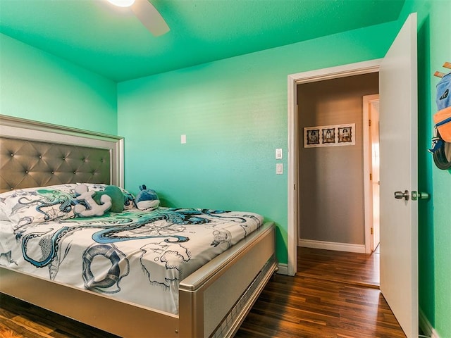 bedroom featuring ceiling fan and dark hardwood / wood-style floors