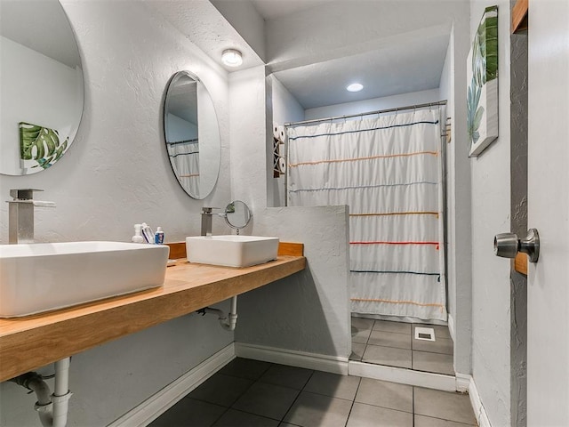 bathroom with tile patterned flooring and vanity