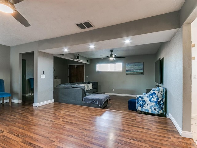 living room with hardwood / wood-style floors and ceiling fan