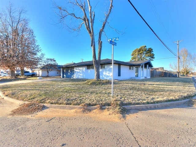 ranch-style home featuring a front yard