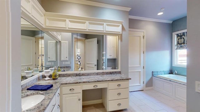 bathroom with vanity, a bath, and crown molding