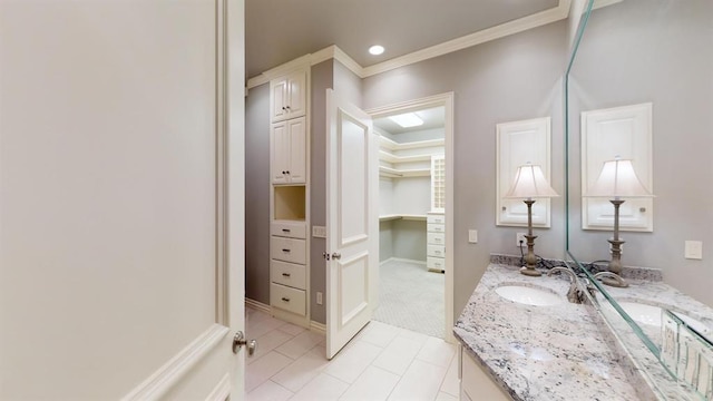 bathroom featuring crown molding, tile patterned floors, and vanity