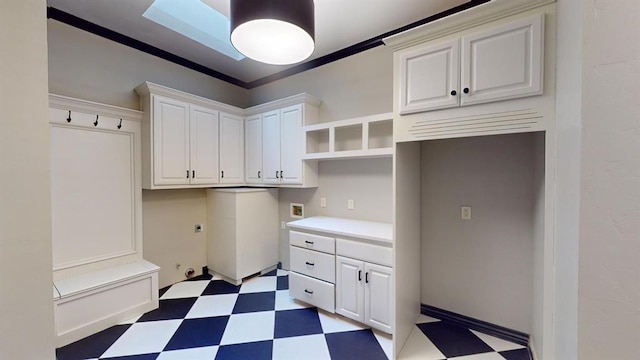 interior space featuring cabinets, ornamental molding, hookup for a washing machine, hookup for an electric dryer, and hookup for a gas dryer