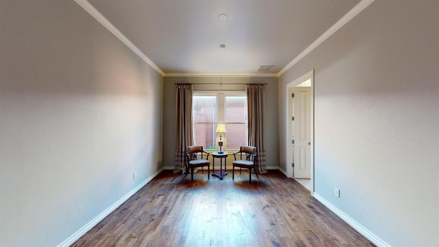 sitting room with crown molding and dark hardwood / wood-style flooring