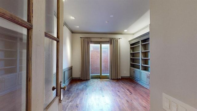 unfurnished room featuring hardwood / wood-style flooring and crown molding