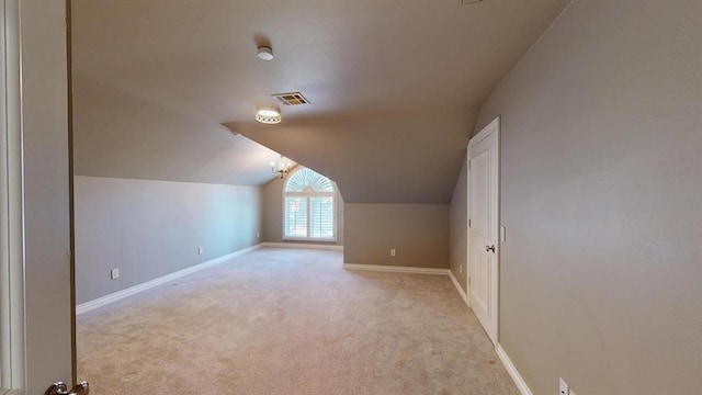 bonus room featuring lofted ceiling and light colored carpet