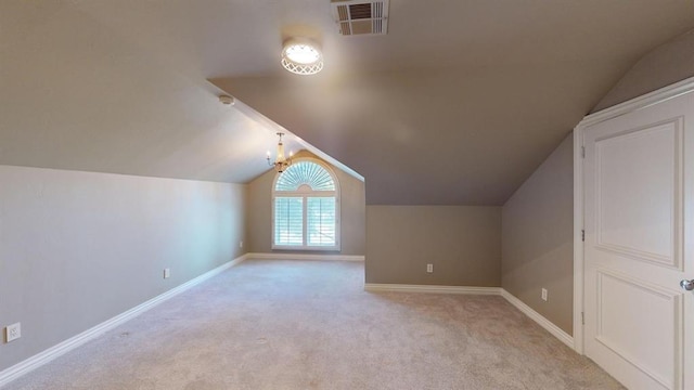 bonus room featuring light colored carpet and vaulted ceiling