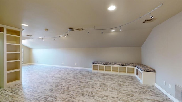 additional living space with lofted ceiling and light wood-type flooring