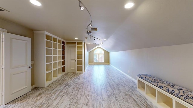 bonus room with light hardwood / wood-style floors and vaulted ceiling