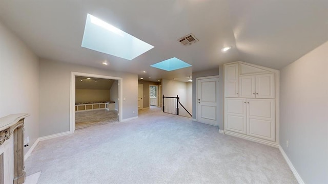 bonus room featuring light colored carpet and vaulted ceiling with skylight