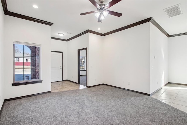 carpeted empty room with ornamental molding and ceiling fan