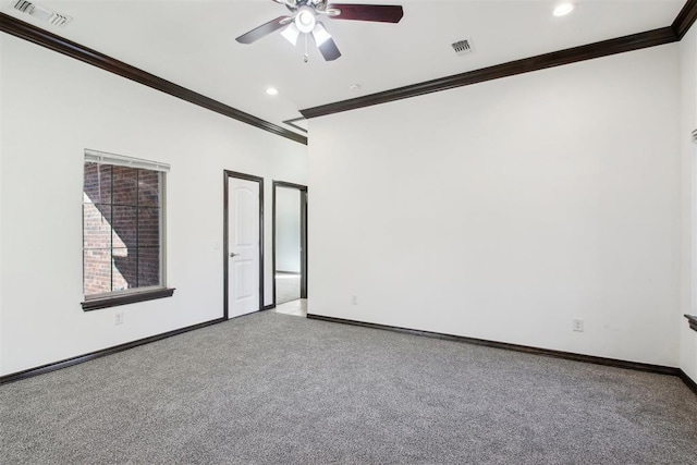 spare room featuring light colored carpet, ornamental molding, and ceiling fan