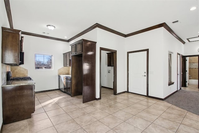 kitchen with dark brown cabinetry, light tile patterned floors, crown molding, and tasteful backsplash