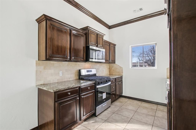 kitchen with dark brown cabinetry, decorative backsplash, ornamental molding, and appliances with stainless steel finishes