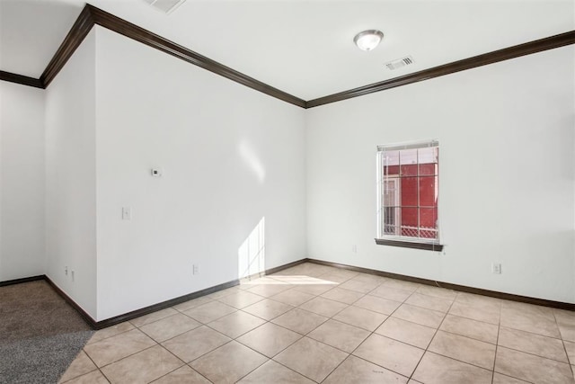 unfurnished room featuring light tile patterned floors, plenty of natural light, and ornamental molding