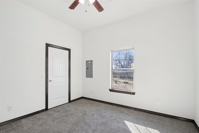 carpeted empty room featuring ceiling fan and electric panel