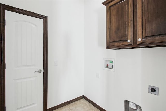 washroom featuring cabinets, washer hookup, hookup for an electric dryer, and light tile patterned floors