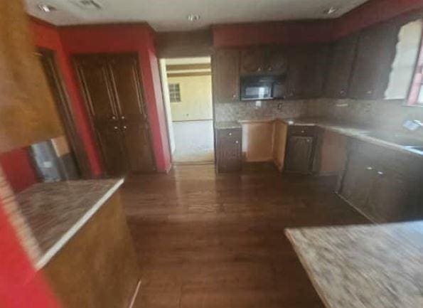 kitchen with dark wood-type flooring