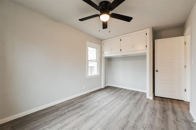 unfurnished bedroom featuring a closet, ceiling fan, and light wood-type flooring