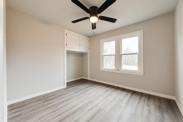 unfurnished bedroom with light hardwood / wood-style flooring, a closet, and ceiling fan