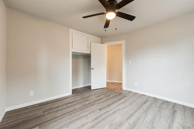 unfurnished bedroom featuring a closet, ceiling fan, and light wood-type flooring