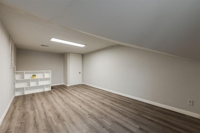 additional living space featuring light hardwood / wood-style flooring