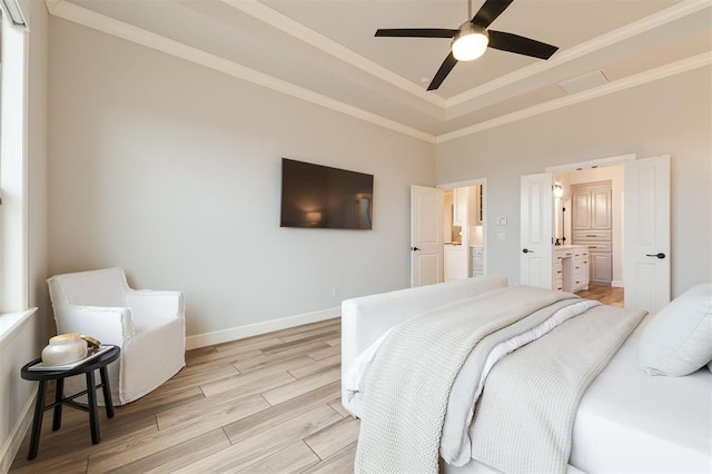 bedroom with ornamental molding, a raised ceiling, light wood-style flooring, and baseboards