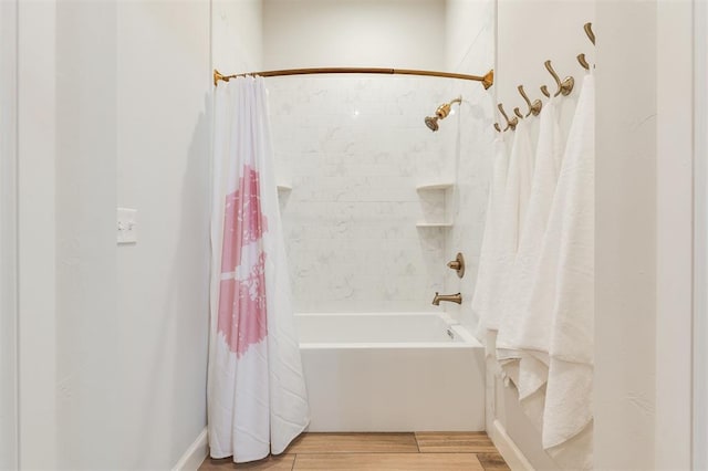 full bath with shower / bath combo with shower curtain and wood finished floors