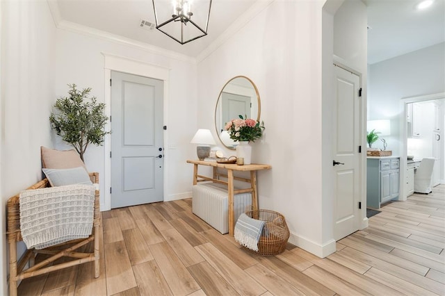 entrance foyer featuring light wood-style floors, visible vents, ornamental molding, and baseboards